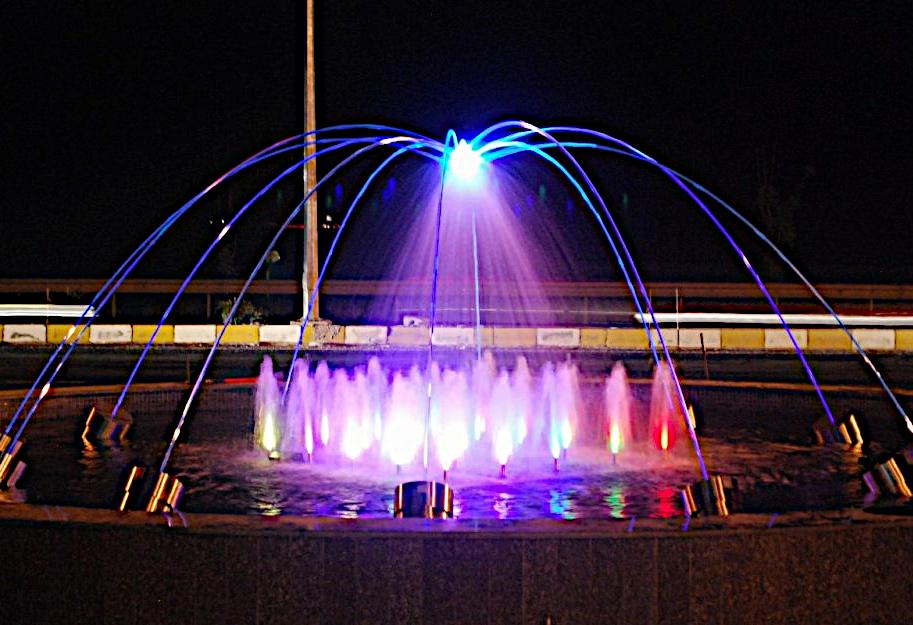 Dome of illuminated water arcs at night