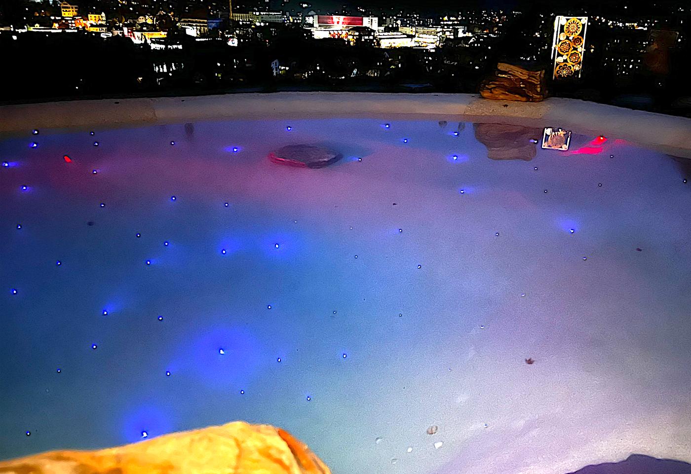 Beach pool with underwater lights at night