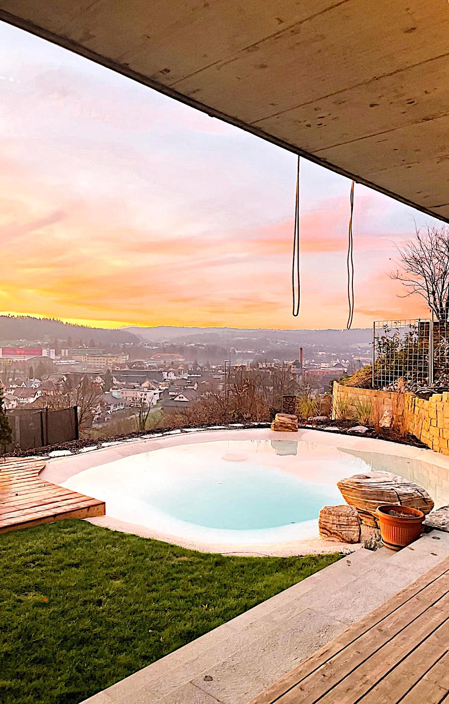 Beach pool at sunset overlooking a city