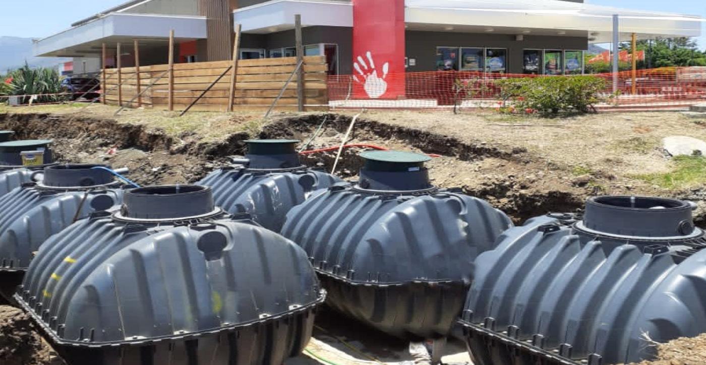 Row of underground treatment tanks ready for installation