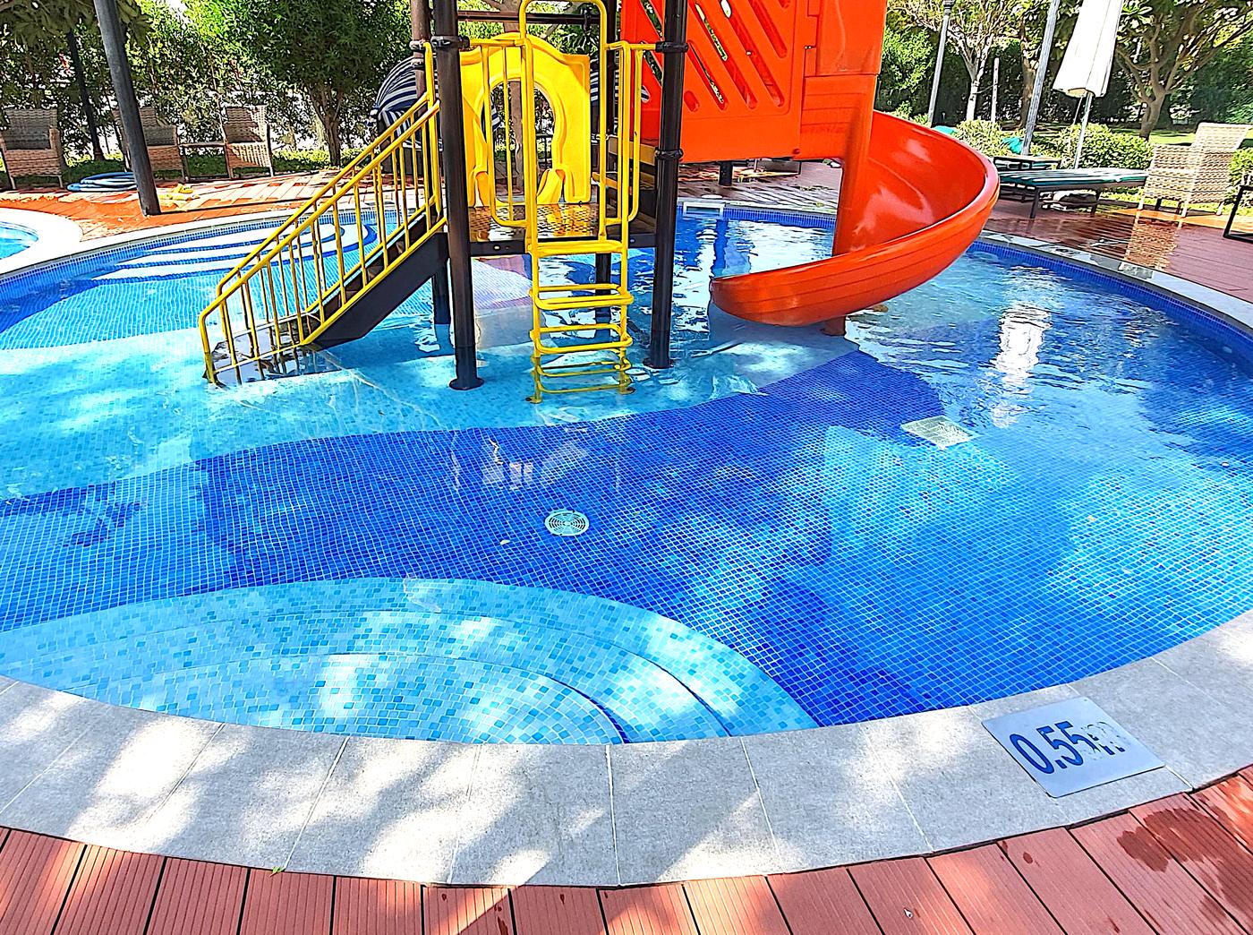Children's pool with a water slide and play tower