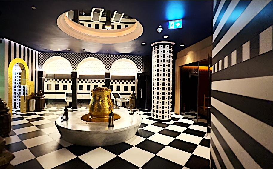 Hammam with a central fountain, arches and a checkered marble floor