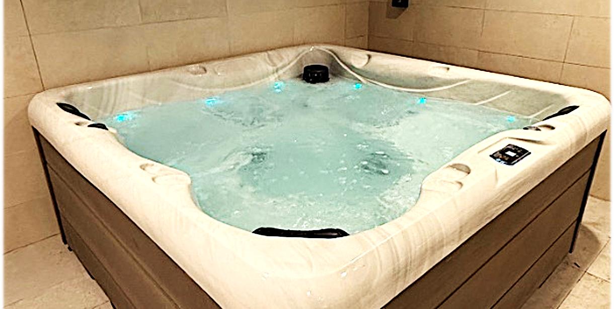 Filled jacuzzi with wood paneling