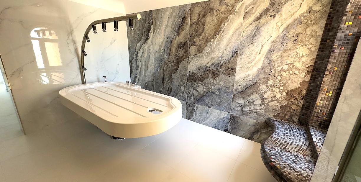 Heated stone lounger in a spa relaxation room