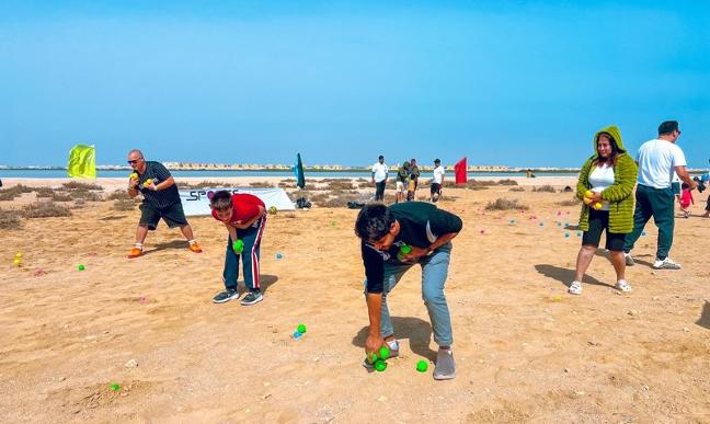 Team playing games on the beach during a team day