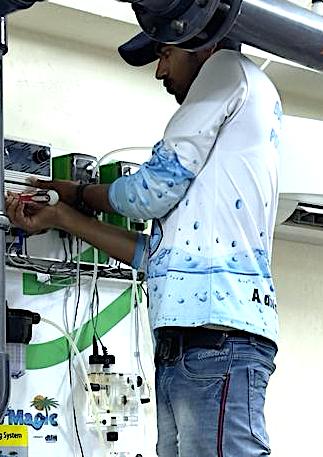 Technician wiring a dosing control panel