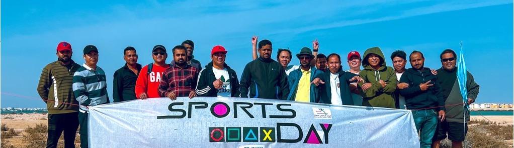 The Aqua Magic team together behind a sports day banner