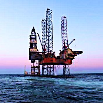 Offshore drilling rig at sea at dusk